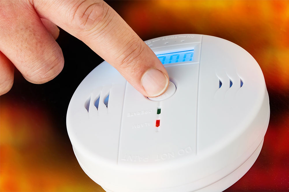 Wall-mounted smoke alarm with test button and LED indicator light