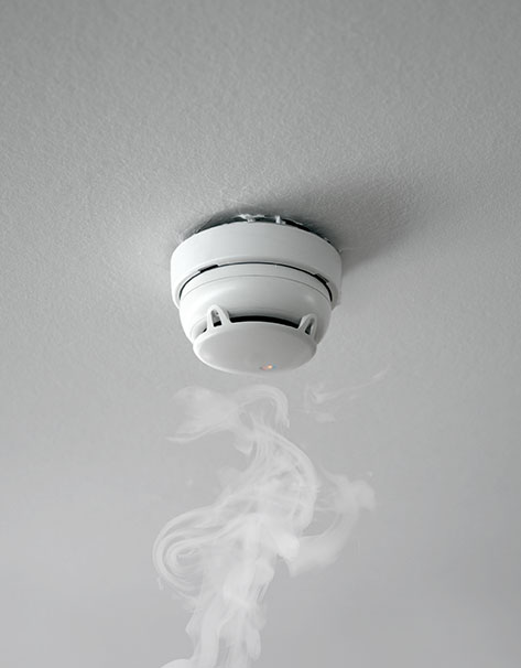 Wall-mounted smoke alarm with test button and LED indicator light